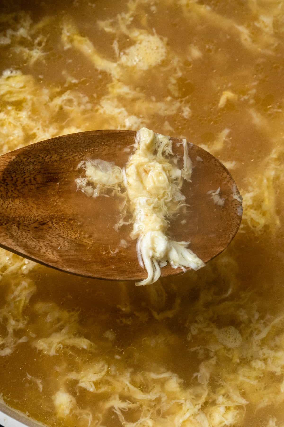 ribbons of egg floating in the egg drop soup broth