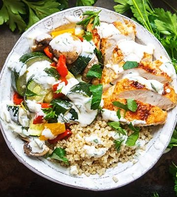 Healthy Greek Chicken Bowl drizzled with Cucumber Yogurt Sauce