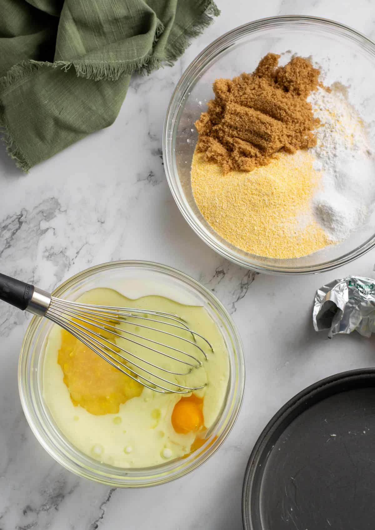 wet and dry ingredients for cornbread in different bowls