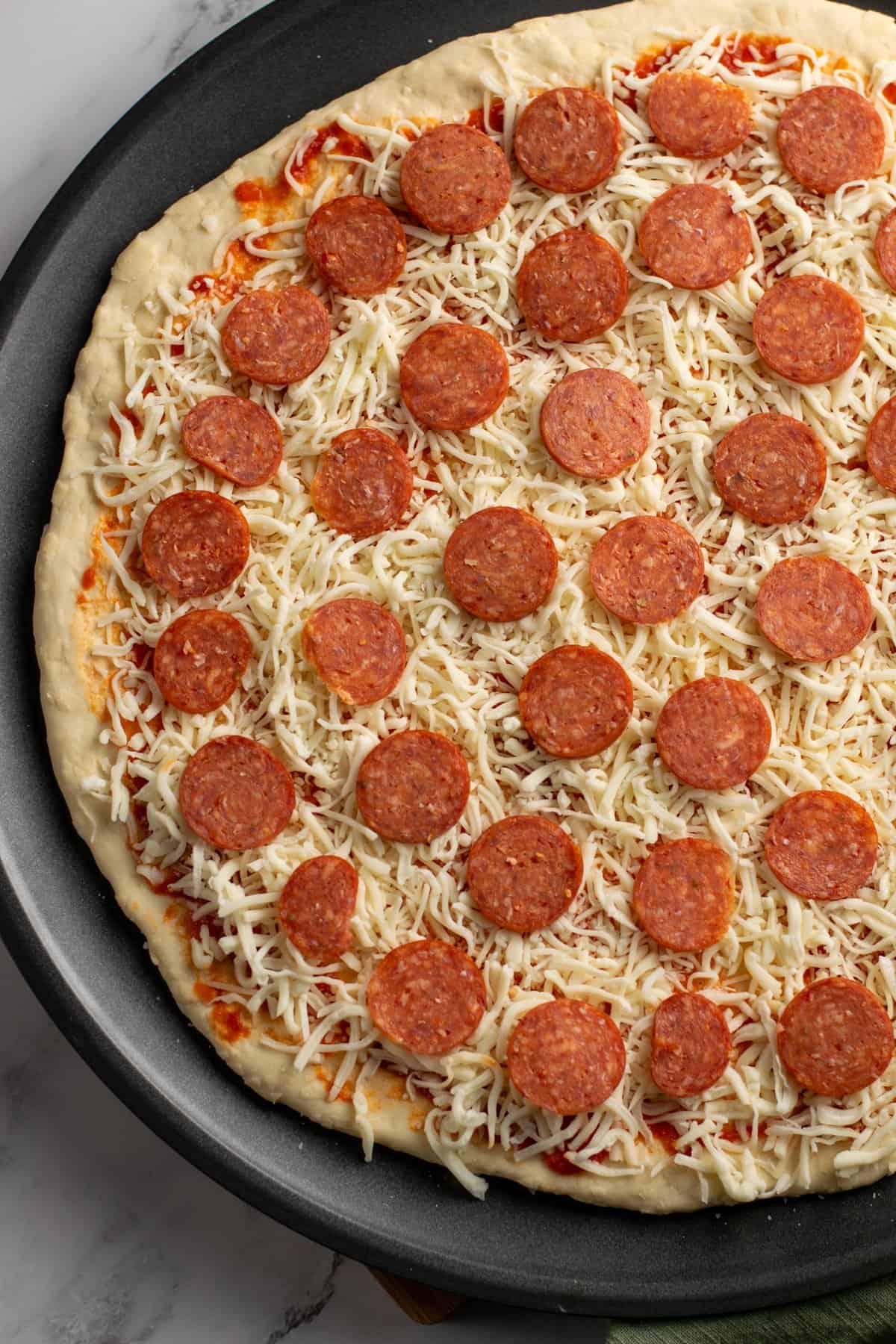 assembling pizza ingredients
